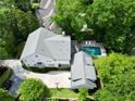 Aerial view of a stunning home with a pool, surrounded by lush greenery and mature trees at 4015 Wieuca Ne Rd, Atlanta, GA 30342