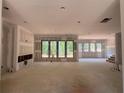 Spacious living room featuring fireplace and abundant natural light, ready for finishing at 101 Deer Canyon Dr, Auburn, GA 30011