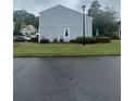 Side view of home with manicured lawn and tidy landscaping at 3414 Bayshore Dr, Atlanta, GA 30340