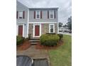 Inviting townhouse with stone accents and red shutters, surrounded by manicured landscaping at 3414 Bayshore Dr, Atlanta, GA 30340
