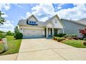 Inviting home featuring a manicured lawn, a two-car garage, and a welcoming entrance at 422 Laurel Spring Ct, Canton, GA 30114