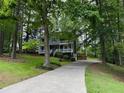 Two-story home with a long driveway surrounded by mature trees at 5307 Red Rock Trce, Powder Springs, GA 30127