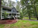 Charming two-story home with double porches surrounded by mature trees at 5307 Red Rock Trce, Powder Springs, GA 30127
