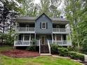 Attractive two-story home with dual balconies, set amidst lush trees at 5307 Red Rock Trce, Powder Springs, GA 30127