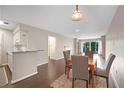 Dining area with hardwood floors open to the living room and kitchen featuring a fireplace at 1312 Pine Heights Ne Dr, Atlanta, GA 30324