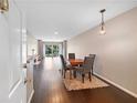 Open dining room with hardwood floors, stylish furniture, and sliding glass doors to the balcony at 1312 Pine Heights Ne Dr, Atlanta, GA 30324