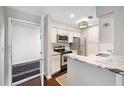 Well-lit kitchen featuring granite countertops, stainless steel appliances, and white cabinetry at 1312 Pine Heights Ne Dr, Atlanta, GA 30324