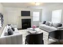 Elegant living room with fireplace, neutral color scheme, and stylish furnishings at 1754 Soapstone Ct, Decatur, GA 30034
