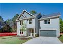 Beautiful two-story home with an attached garage, complemented by a well-manicured lawn and sunny skies at 3352 Landings South Dr, Atlanta, GA 30331