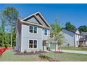 Side view of a modern two-story home featuring gray siding and a well-maintained lawn with landscaping at 3352 Landings South Dr, Atlanta, GA 30331