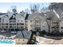 Exterior view of condominiums with parking, pool and building exteriors in neutral paint at 3655 Habersham Ne Rd # 244B, Atlanta, GA 30305