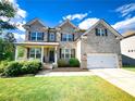 Charming two-story brick home with a well-manicured lawn and attached two car garage at 7860 Bristol Valley Dr, Cumming, GA 30028