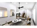Inviting living room with neutral tones, modern furniture, ceiling fan, and views into the updated kitchen at 1241 Bethsaida Rd, Riverdale, GA 30296