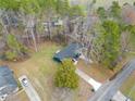 An aerial view shows the home nestled among trees on a spacious lot with a long driveway at 26 Alisha Nw Cir, Cartersville, GA 30121
