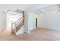 Bright home interior featuring a wooden staircase, hardwood floors, and coffered ceilings at 4222 Matisse Ln, Fairburn, GA 30213