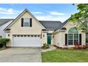 Inviting home with a two-car garage, green front door and well kept lawn at 121 St Albans Way, Peachtree City, GA 30269