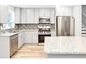 Well-lit kitchen with granite countertops, stainless steel appliances, and white cabinetry at 2247 Green Forrest Dr, Decatur, GA 30032