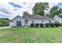 Charming one-story home with large arched windows and well-maintained landscaping at 500 Birch Forest Ln, Alpharetta, GA 30005
