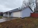 View of the side of the house and 2-car garage at 563 Fieldgreen Dr, Jonesboro, GA 30238