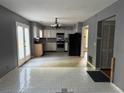 Well-lit kitchen with white cabinets, stainless steel appliances, and access to outdoor patio at 2032 Hopkins Mill Road, Duluth, GA 30096