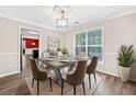 Formal dining area with modern lighting, neutral walls, and a view into the kitchen at 2967 Albright Cmns, Kennesaw, GA 30144
