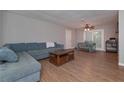 Open-concept living room with hardwood floors, a comfy blue couch and neutral-colored walls at 3000 Kennesaw Nw Dr, Kennesaw, GA 30152