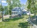 Stately two-story home with attached garage and well-manicured lawn at 173 Springwater Trce, Woodstock, GA 30188