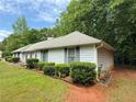 Well-maintained home exterior featuring tidy landscaping and mature trees at 235 Creekside Way, Mcdonough, GA 30252