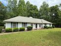 Well-maintained single-story home with lush green lawn and mature trees at 235 Creekside Way, Mcdonough, GA 30252