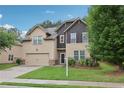 Two-story home with a two-car garage, green lawn, and mature landscaping at 2760 Lions Gate Dr, Cumming, GA 30041