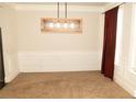 Bright dining room with modern lighting and ample space for entertaining at 305 Anise Ct, Mcdonough, GA 30252
