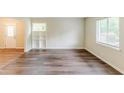 Cozy living area featuring new hardwood floors, two large windows and a built-in shelving unit at 3197 Ward Sw Dr, Atlanta, GA 30354