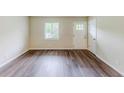 Bright living room featuring new hardwood flooring, white walls and a window with wood blinds at 3197 Ward Sw Dr, Atlanta, GA 30354