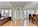 Bright foyer with hardwood floors and elegant columns leading to the adjacent rooms at 645 Earlham Dr, Suwanee, GA 30024
