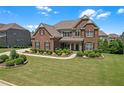 Charming brick home with meticulous landscaping and a lush green lawn, perfect for families at 2520 Wood Fern Ln, Cumming, GA 30041