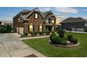 Beautiful home featuring brick exterior, manicured lawn, and an attached garage, set against a twilight sky at 2520 Wood Fern Ln, Cumming, GA 30041