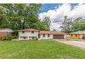 Charming two-story home with a brick exterior, green lawn, and attached two-car garage at 3275 Clifton Church Se Rd, Atlanta, GA 30316