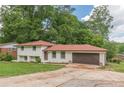Charming two-story home with a brick exterior, green lawn, and attached two-car garage at 3275 Clifton Church Se Rd, Atlanta, GA 30316