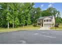 Charming two-story home is situated on a corner lot with mature trees at 5320 Flat Rock Pt, Lithonia, GA 30038