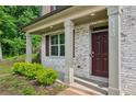 Close-up of a home's front entrance with a stylish door and well-kept landscaping at 5320 Flat Rock Pt, Lithonia, GA 30038