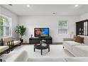 Bright living room with neutral walls, plush seating, and plenty of natural light at 5320 Flat Rock Pt, Lithonia, GA 30038