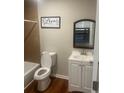 Bathroom featuring a toilet, vanity, mirror, and shower with tile surround at 10 Rockmart Nw Dr, Atlanta, GA 30314