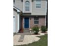 Charming two-story home features a blue front door, partial brick facade, and a well-manicured lawn at 3753 Soapstone Rd, Decatur, GA 30034