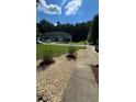 Two-story home featuring a well-manicured lawn and garden at 3753 Soapstone Rd, Decatur, GA 30034