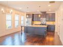 Spacious kitchen with stainless steel appliances, granite countertops, and hardwood floors at 4448 Tacoma Trce, Suwanee, GA 30024