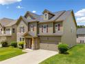 Traditional home with stone and siding exterior, complemented by lush greenery at 4920 Fourth Rail Ln, Cumming, GA 30040