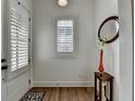 Bright entryway features hardwood floors, white walls and trim, and modern decor at 1006 Fendley St, Woodstock, GA 30188