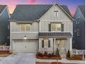 Charming two-story home featuring a two-car garage and covered porch at 1006 Fendley St, Woodstock, GA 30188