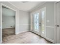 Bright foyer featuring a glass-paneled front door, light gray walls, and laminate flooring at 1523 Pangborn Station Dr, Decatur, GA 30033