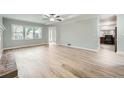 Open living room featuring natural light, neutral walls, and light wood laminate flooring at 1523 Pangborn Station Dr, Decatur, GA 30033